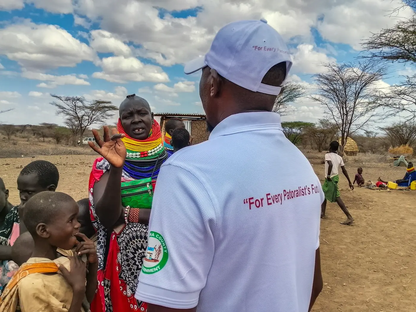 A PAIR team member talking with a woman in Kopeto Village.