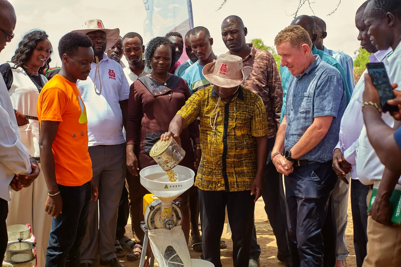 People gathered around the new solar-powered mill in Natoot at its launch.