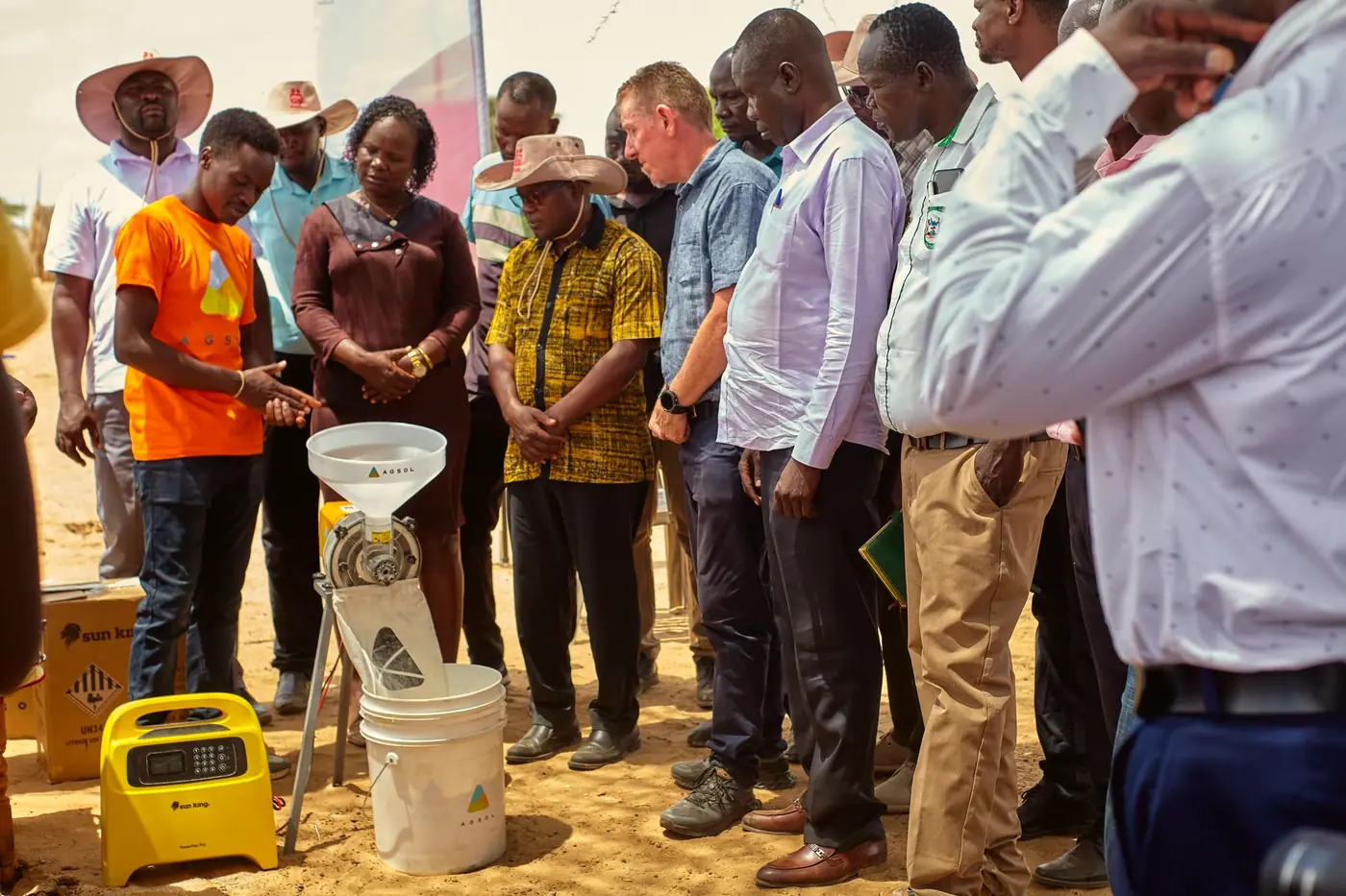 Grain being poured into the solar-powered mill at its launch in Natoot.