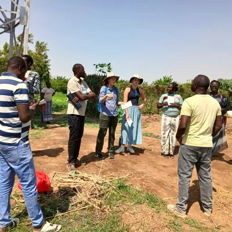 Researchers and community members walking during fieldwork.