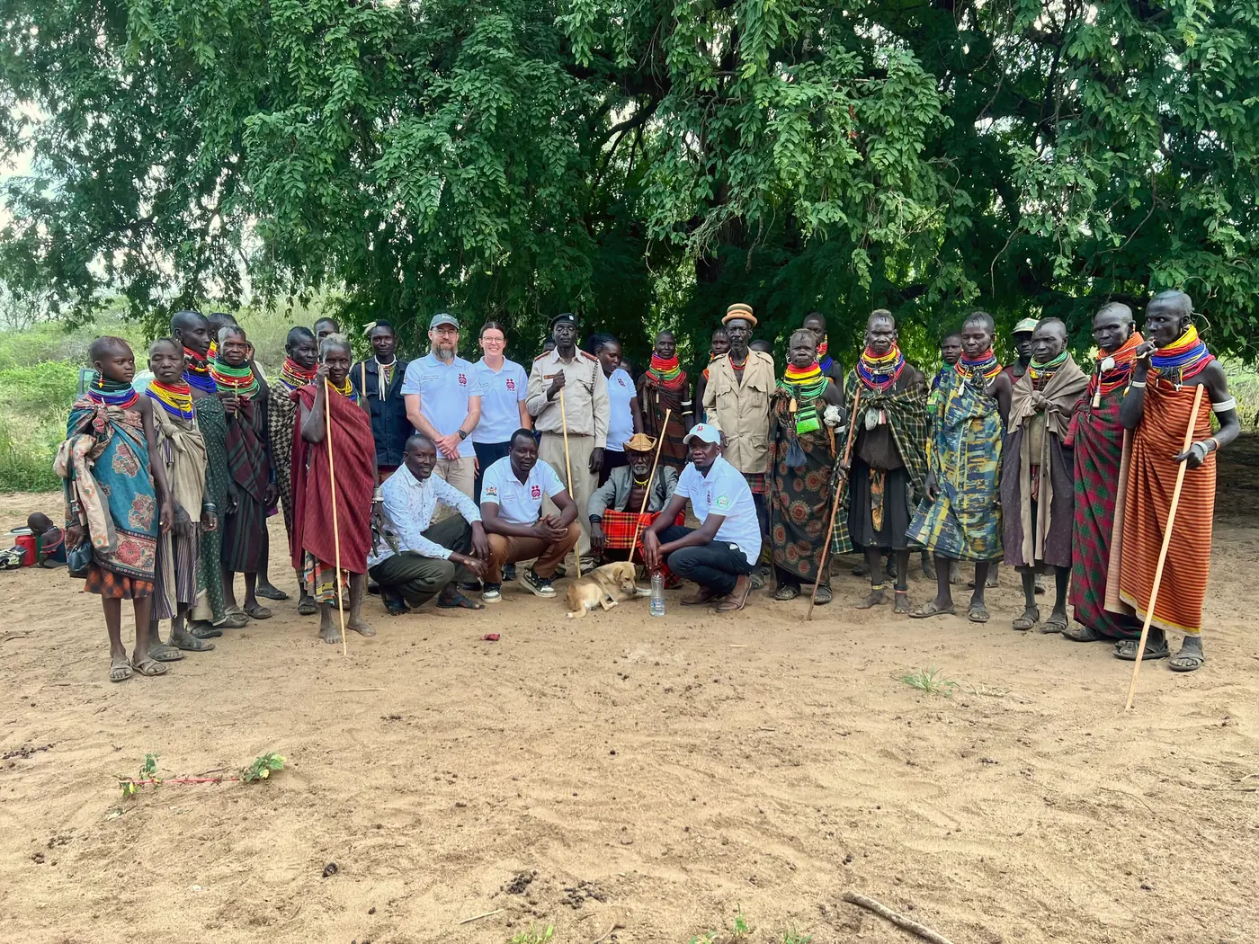 The COHI research team with focus group participants under a tree in Komio.